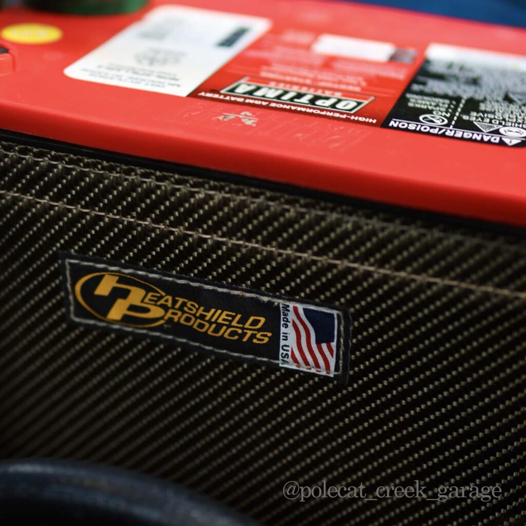 up close picture of lava rock battery shield around an optima red top battery made in the usa