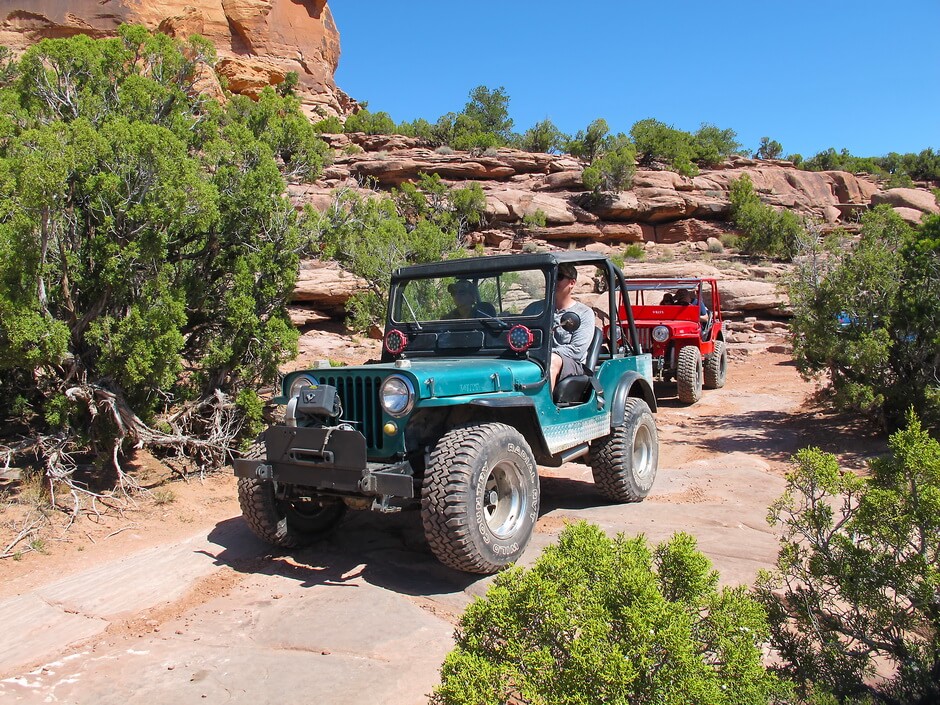 Red and Blue Jeep Drive Through Moab 