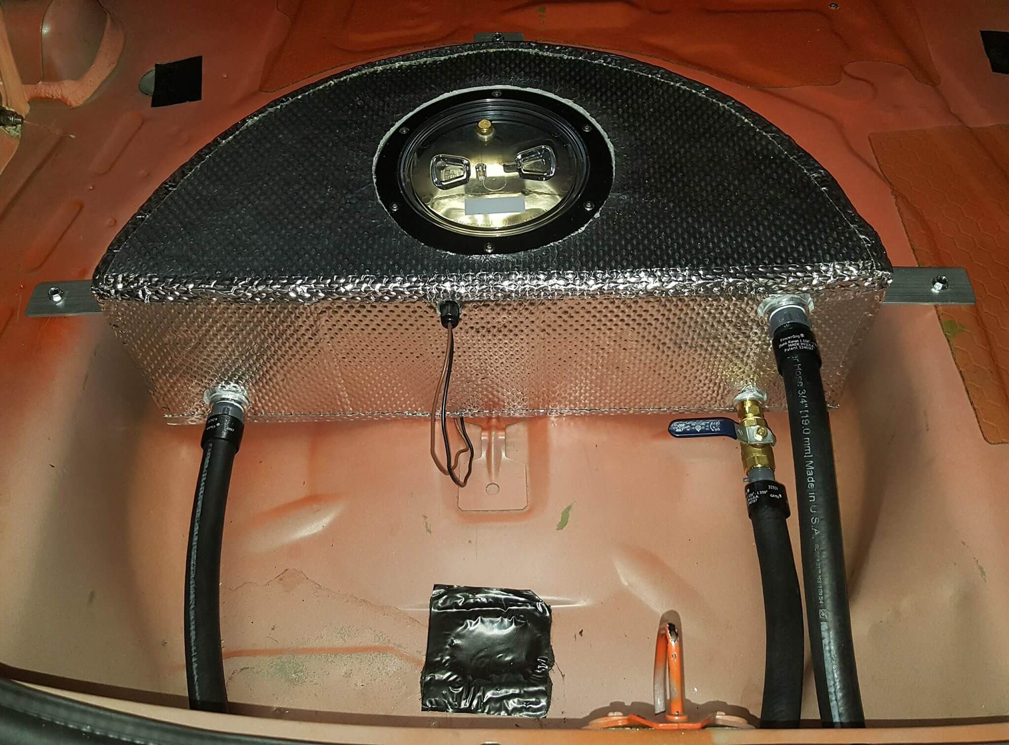 A custom intercooler with heat shield is installed back into the car.