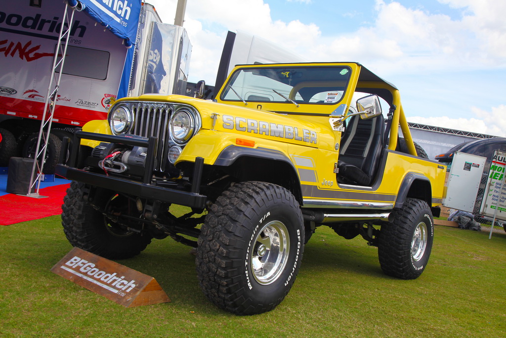 Bright Yellow Jeep Sits Parked on Grass at Car Show