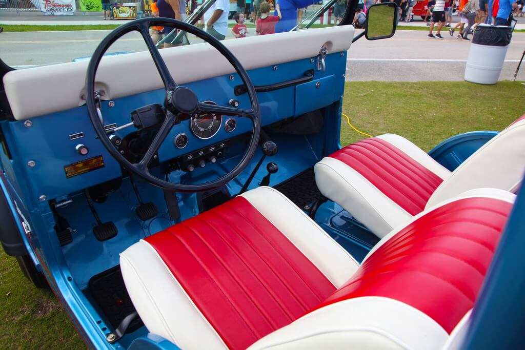 Inside View of Jeep's Bright Blue, White, and Pink Passenger Cabin