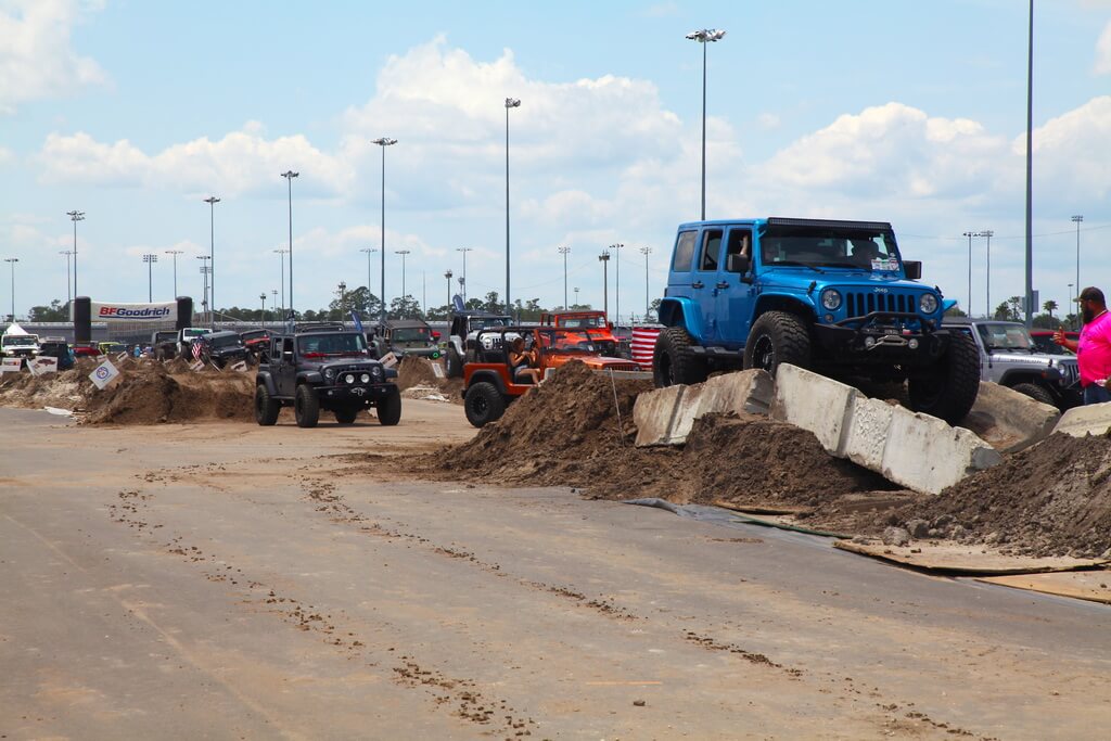Colorful Jeeps Drive Over Rocky Obstacle Course