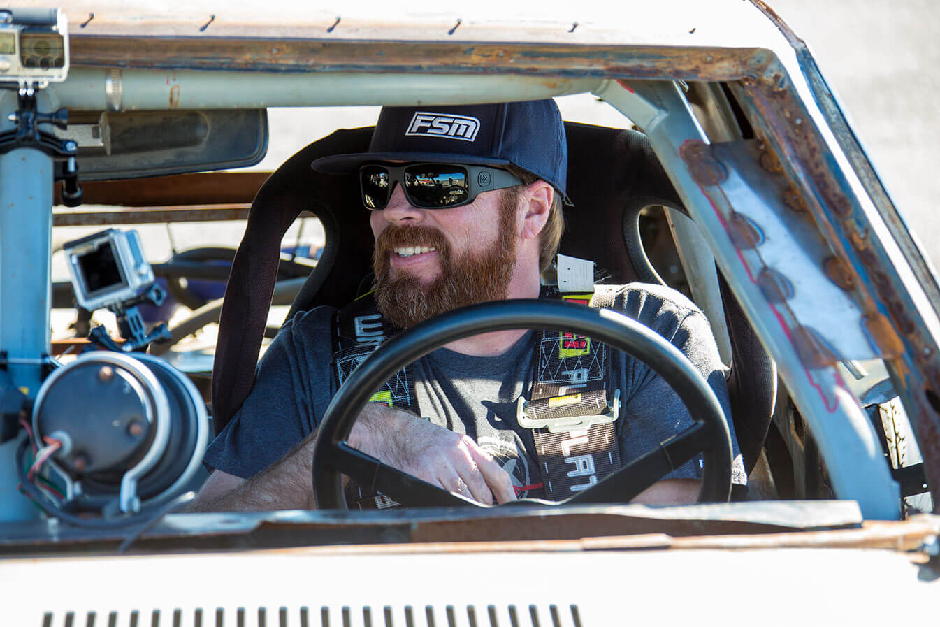 Smiling Man Behind Wheel of UTV