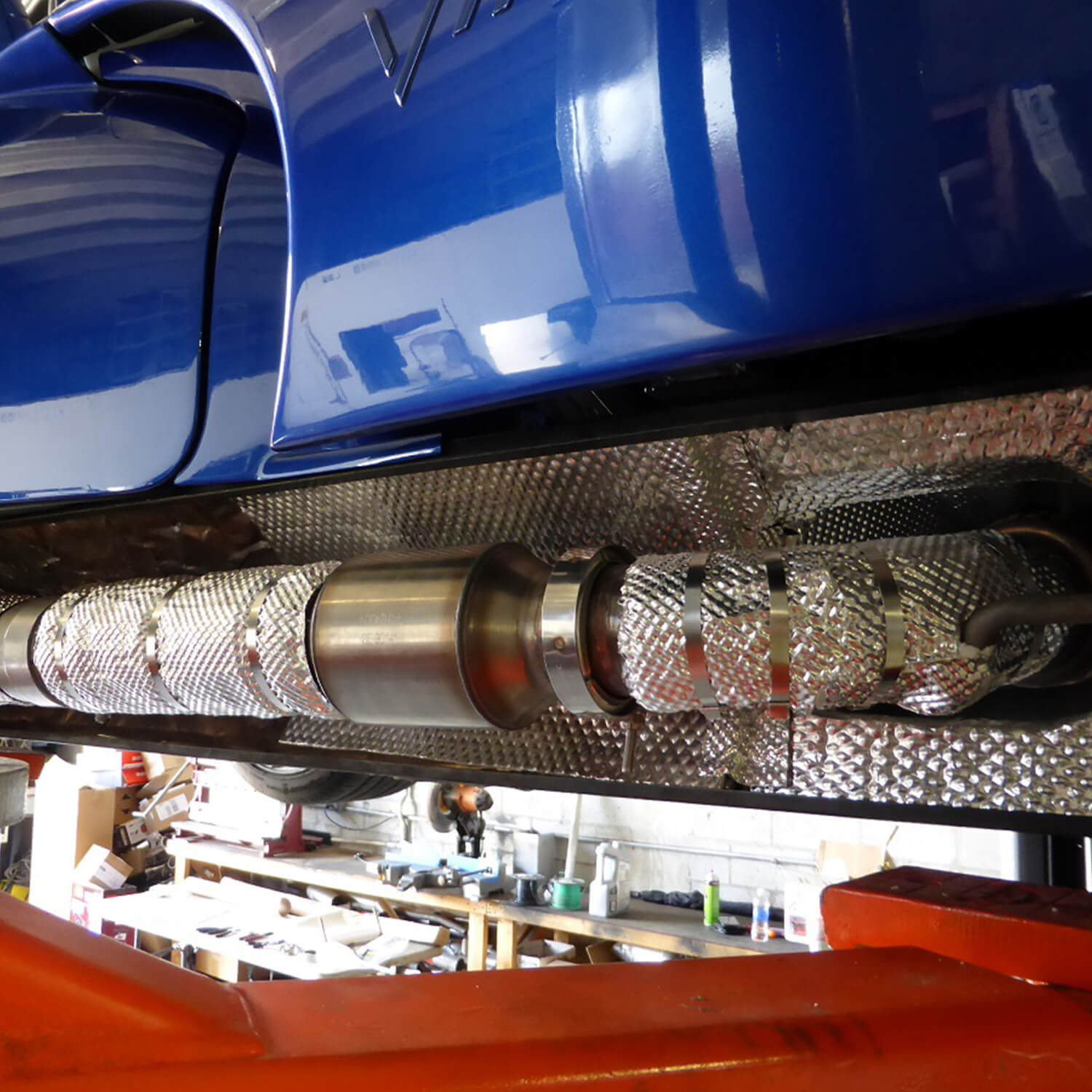 Car Exhaust Pipe Wrapped in a Heat Shield