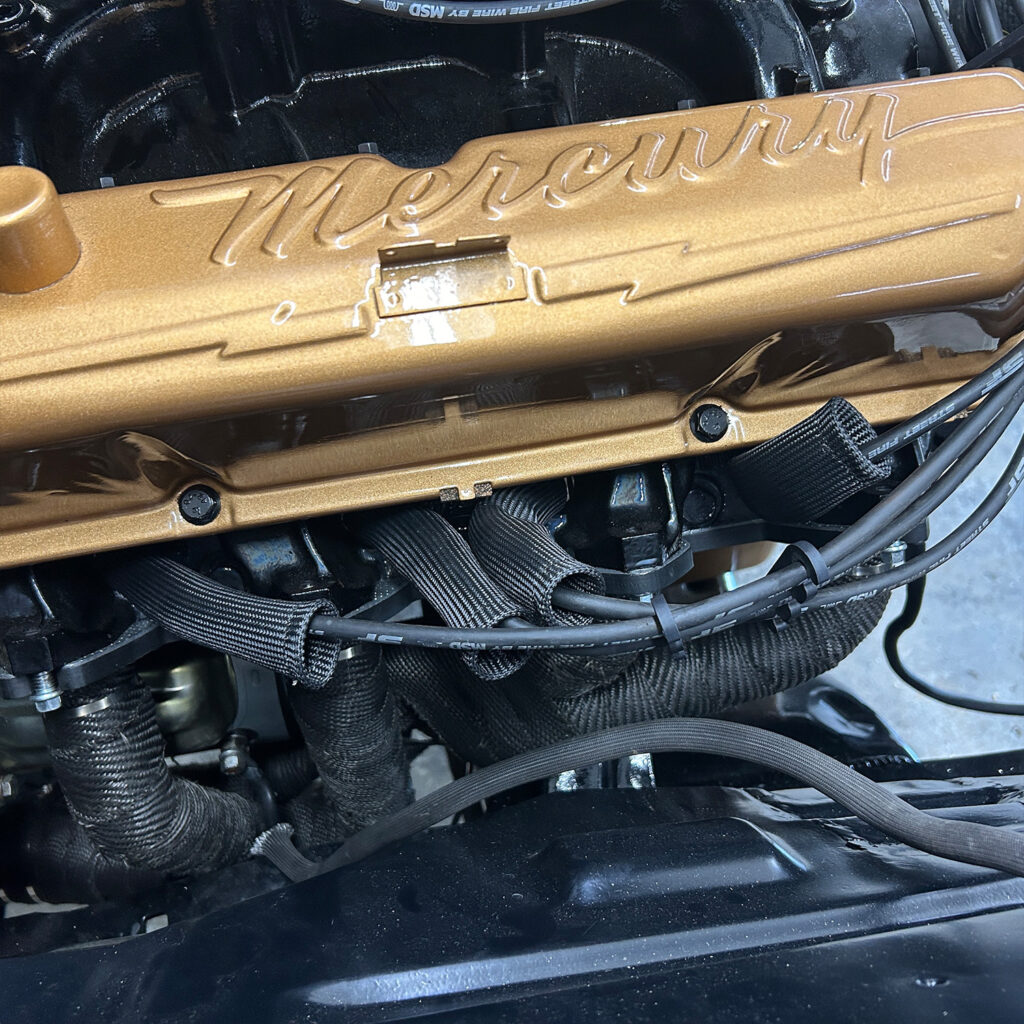 V8 motor with spark plug heat shields