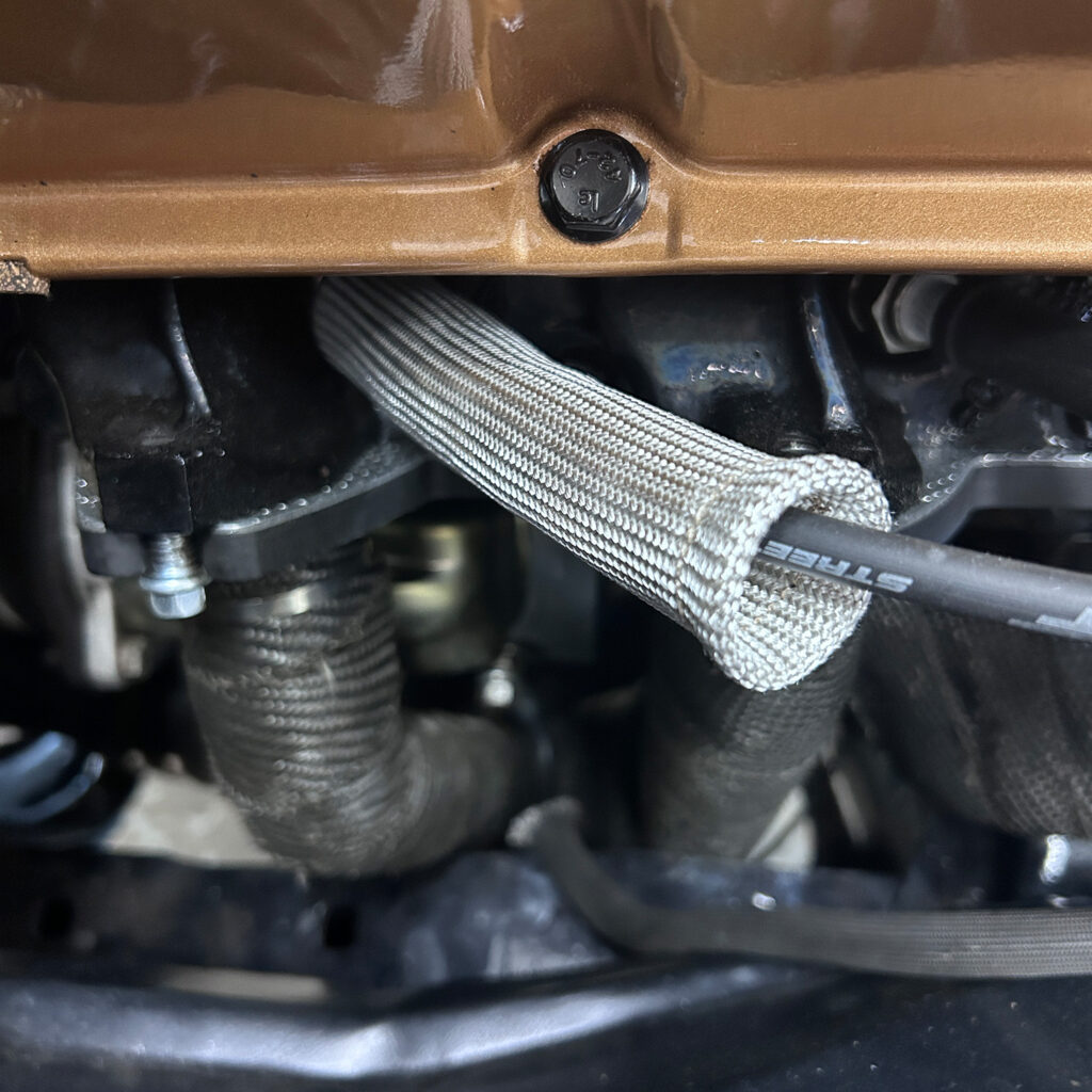 Natural fiber glass spark plug heat shield