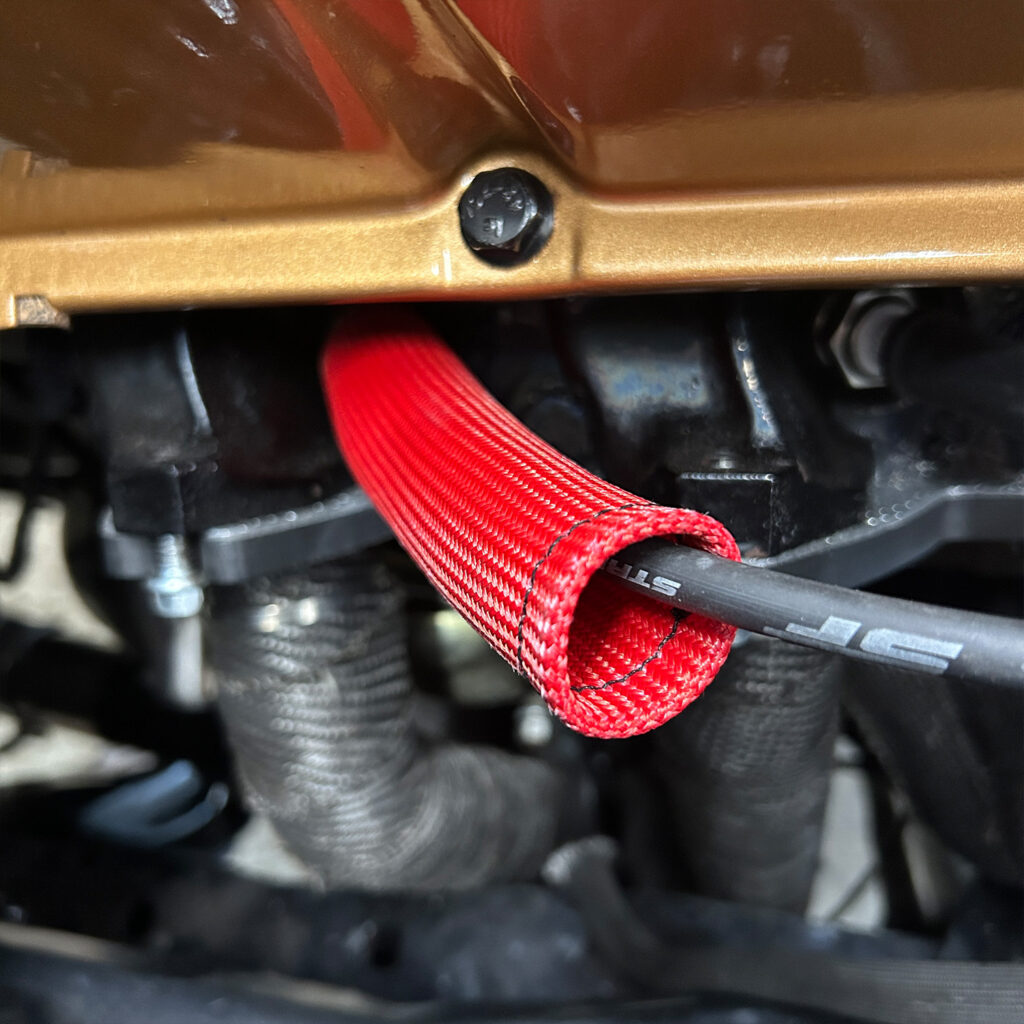 Red heat shield for spark plug