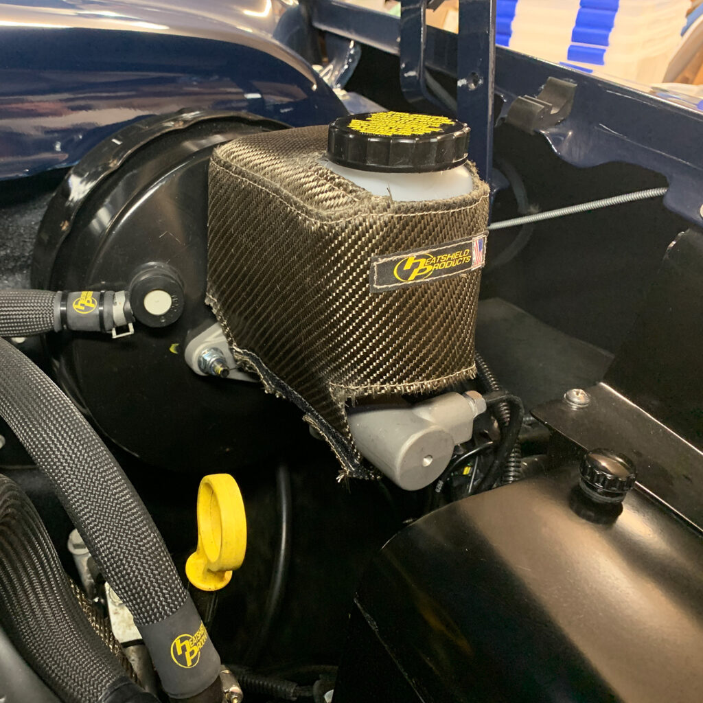 Custom-fitted master cylinder heat shield by Heatshield Products, providing superior thermal protection and a clean, professional look under the hood.