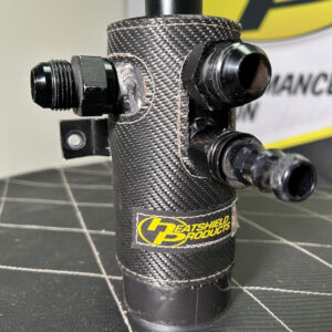 High-performance oil catch can with custom Heatshield Products insulation, featuring precision-stitched carbon fiber material for maximum heat protection.