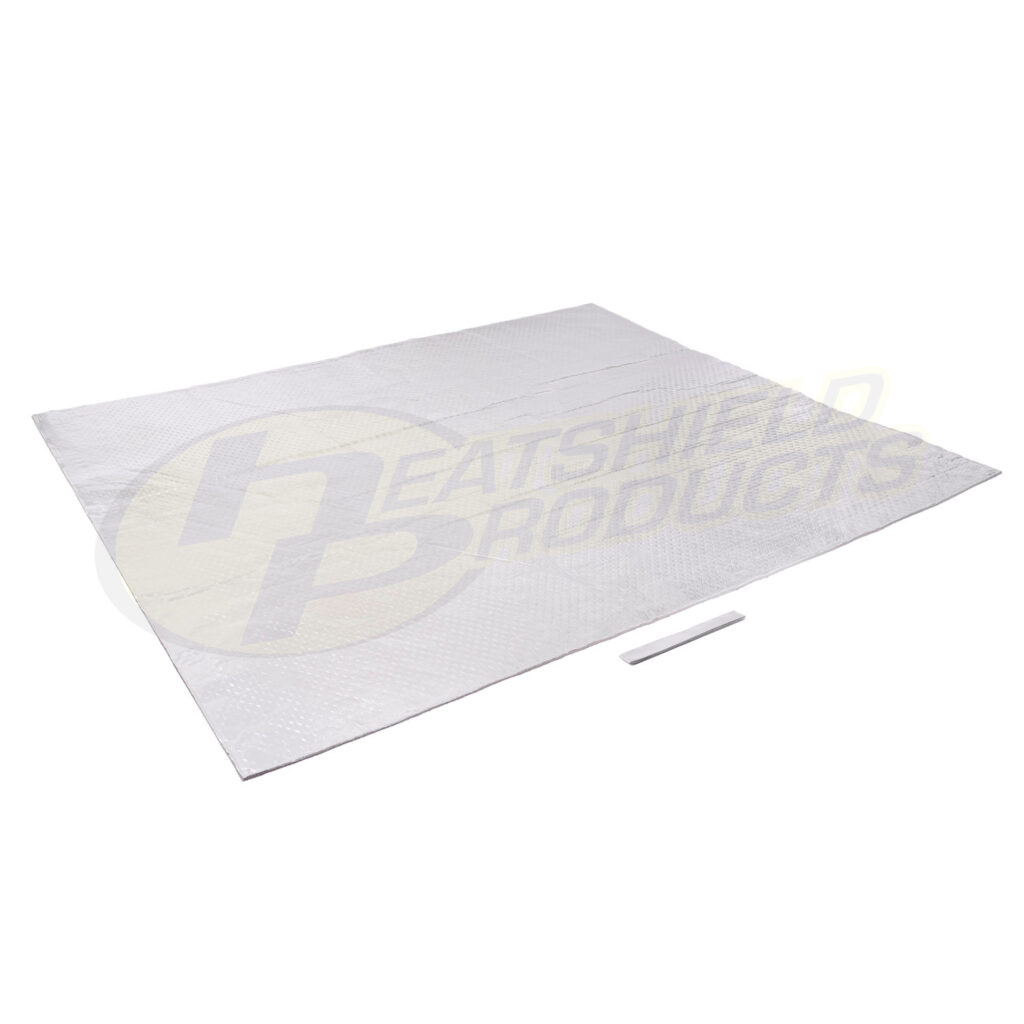 A large, rectangular silver heat shield mat is laid flat on a white background with a small white strip placed near the bottom edge.