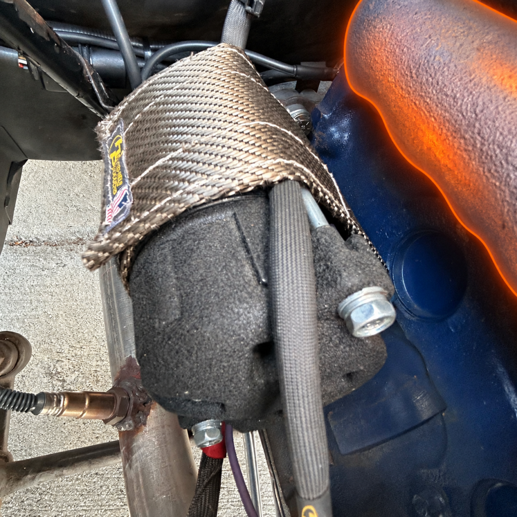 Starter heat shield near exhaust manifold with highlighted heat source
